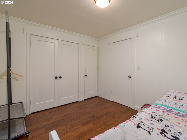 unfurnished bedroom featuring ornamental molding and dark hardwood / wood-style floors