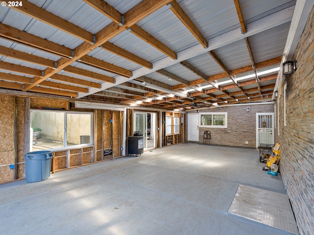 miscellaneous room with concrete flooring and brick wall