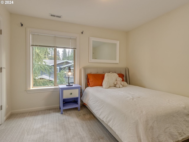 bedroom with carpet floors, baseboards, and visible vents