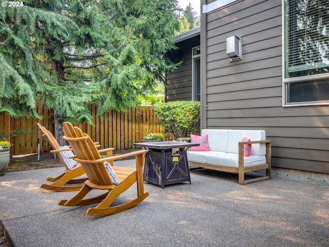 view of patio with a fire pit and fence