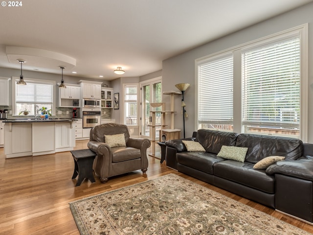 living area featuring recessed lighting, a wealth of natural light, and light wood-style floors