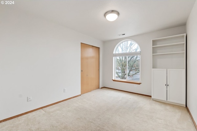 unfurnished bedroom featuring light colored carpet