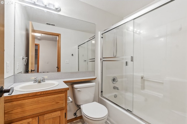 full bathroom with vanity, combined bath / shower with glass door, and toilet