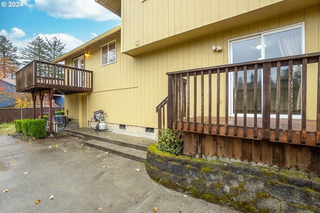 view of side of home featuring a deck and a patio