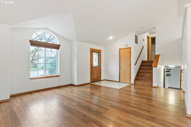 entryway featuring wood-type flooring and vaulted ceiling