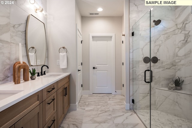 bathroom featuring vanity and an enclosed shower