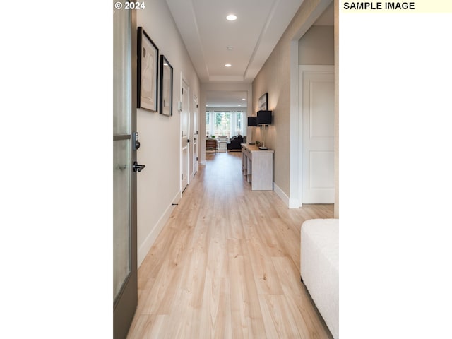 corridor with light hardwood / wood-style floors