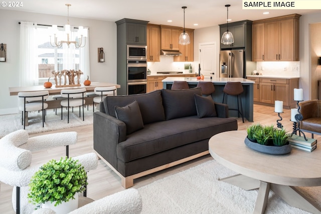 living room featuring light hardwood / wood-style floors and an inviting chandelier