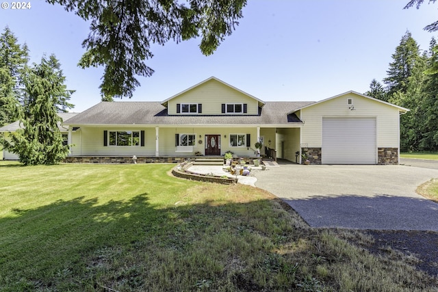 view of front of home with a front lawn, a porch, and a garage