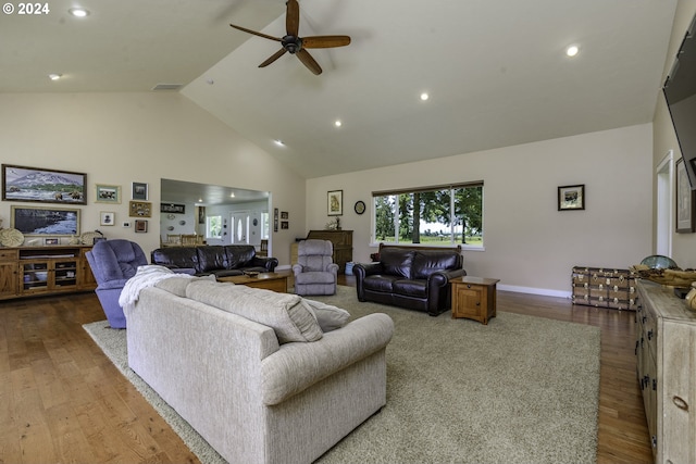 living room featuring hardwood / wood-style flooring, high vaulted ceiling, and ceiling fan