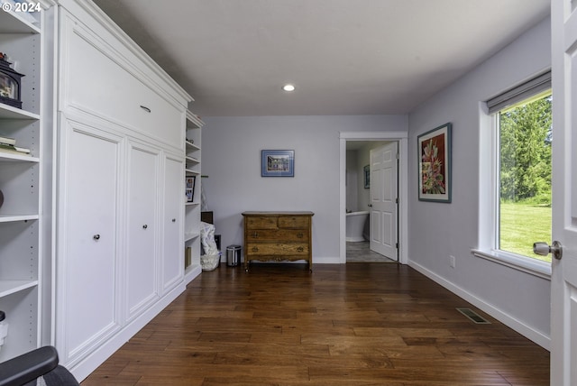 corridor featuring dark wood-type flooring