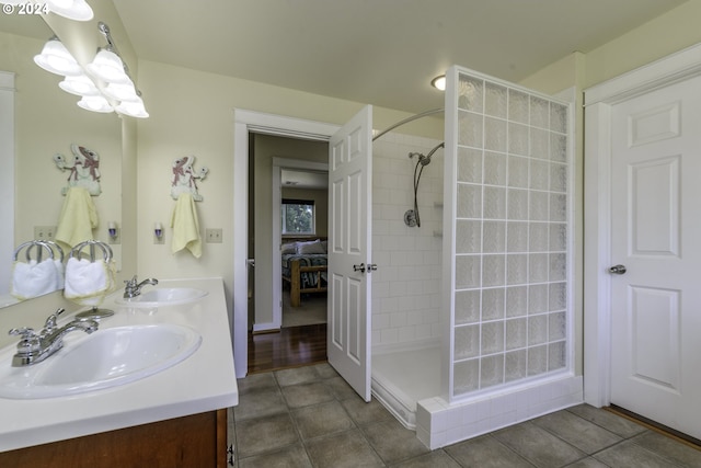 bathroom with tiled shower and vanity