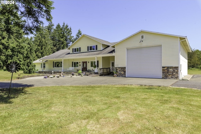 view of front facade with covered porch, a front yard, and a garage