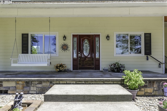 doorway to property featuring covered porch