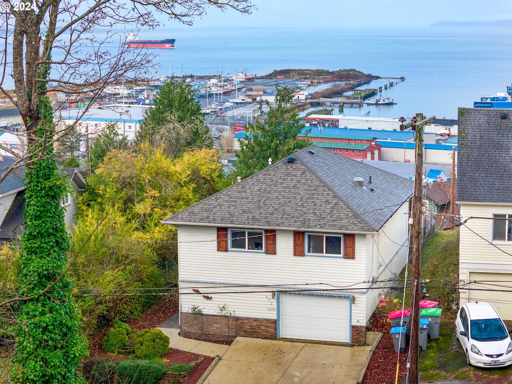 view of front of house with a garage and a water view