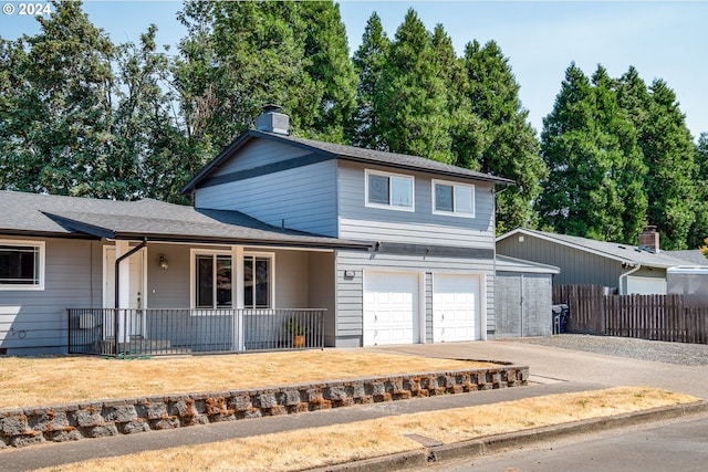 front of property featuring covered porch and a garage