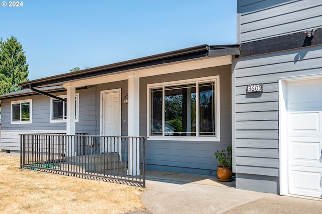 view of exterior entry featuring a porch