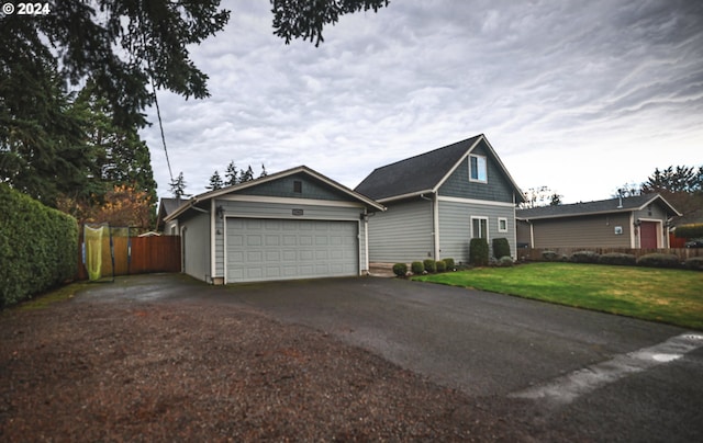 view of side of property with a garage and a yard