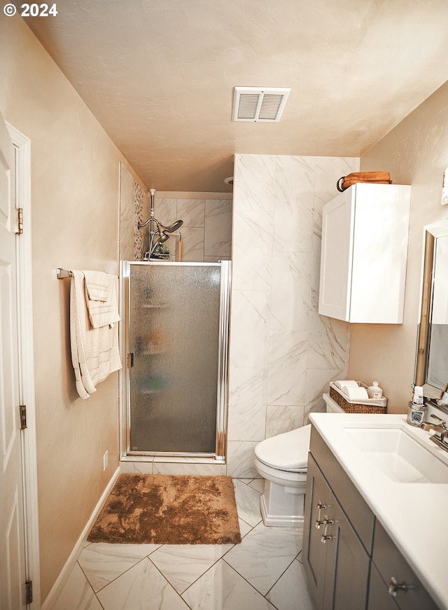 bathroom featuring vanity, toilet, a shower with door, and tile walls