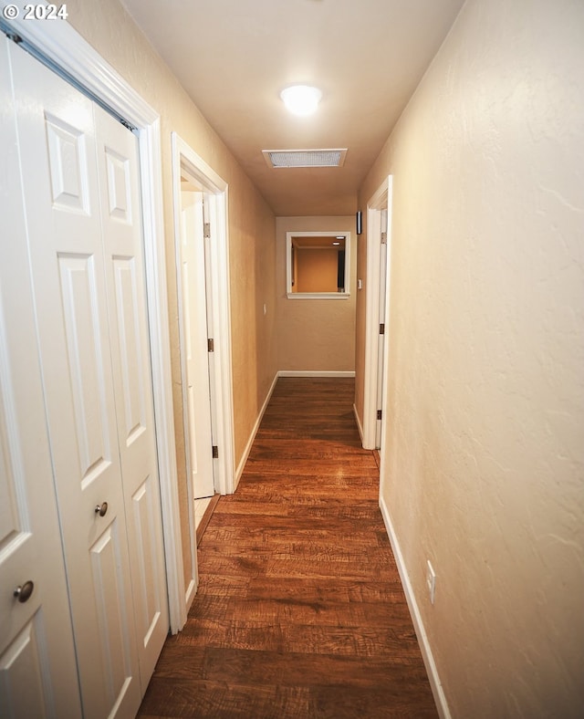 corridor featuring dark hardwood / wood-style floors