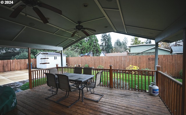 deck featuring a shed and ceiling fan