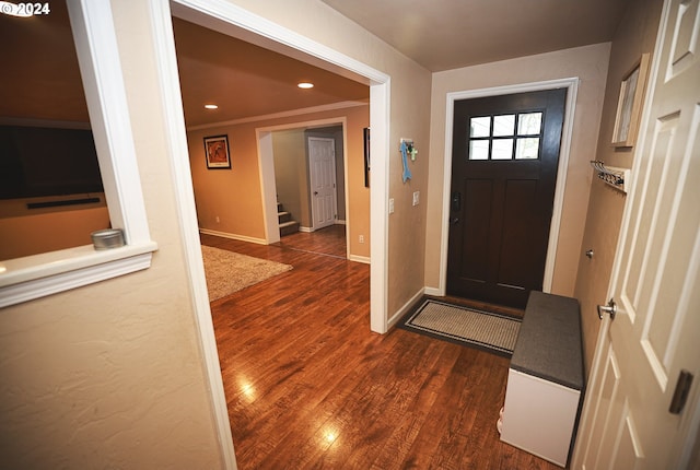 entryway featuring dark hardwood / wood-style floors and ornamental molding