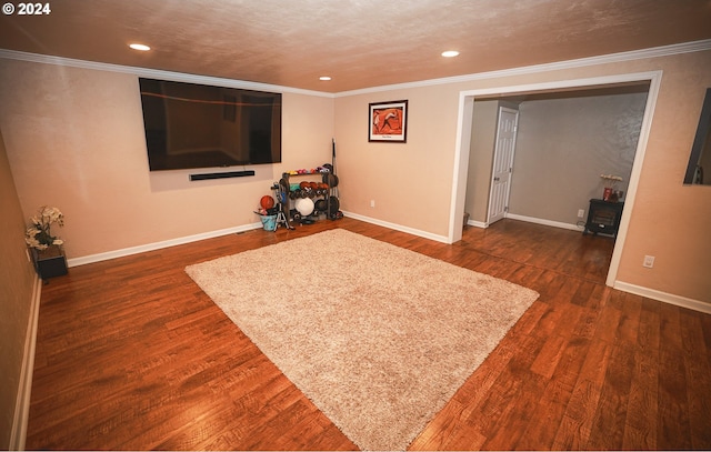 interior space with a textured ceiling, dark hardwood / wood-style flooring, and ornamental molding