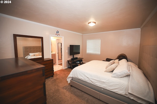 carpeted bedroom featuring crown molding and ensuite bath