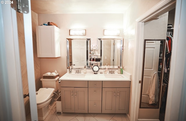 bathroom featuring tile patterned floors, vanity, and toilet