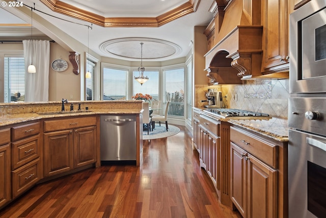 kitchen featuring dark hardwood / wood-style floors, stainless steel appliances, sink, and a wealth of natural light