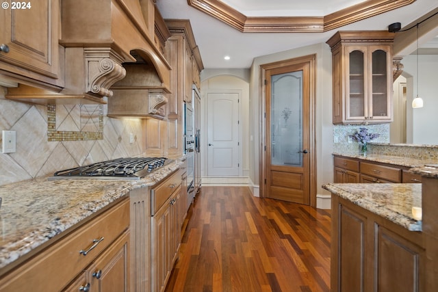 kitchen with dark wood-type flooring, backsplash, decorative light fixtures, and stainless steel gas stovetop