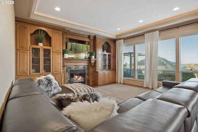 living room featuring crown molding and a fireplace