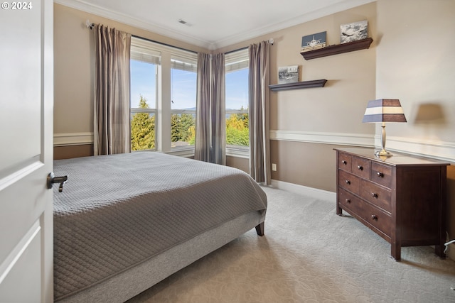 bedroom featuring ornamental molding and light colored carpet