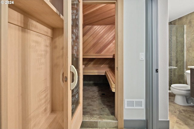 view of sauna / steam room featuring wooden walls