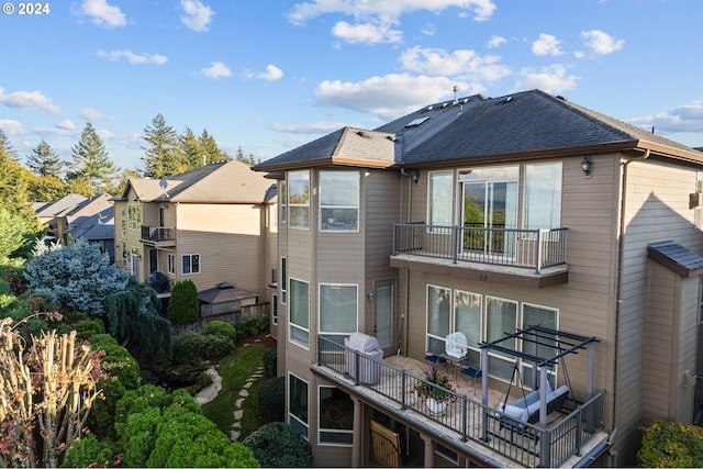 back of property featuring a balcony