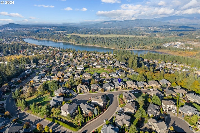 aerial view featuring a water and mountain view