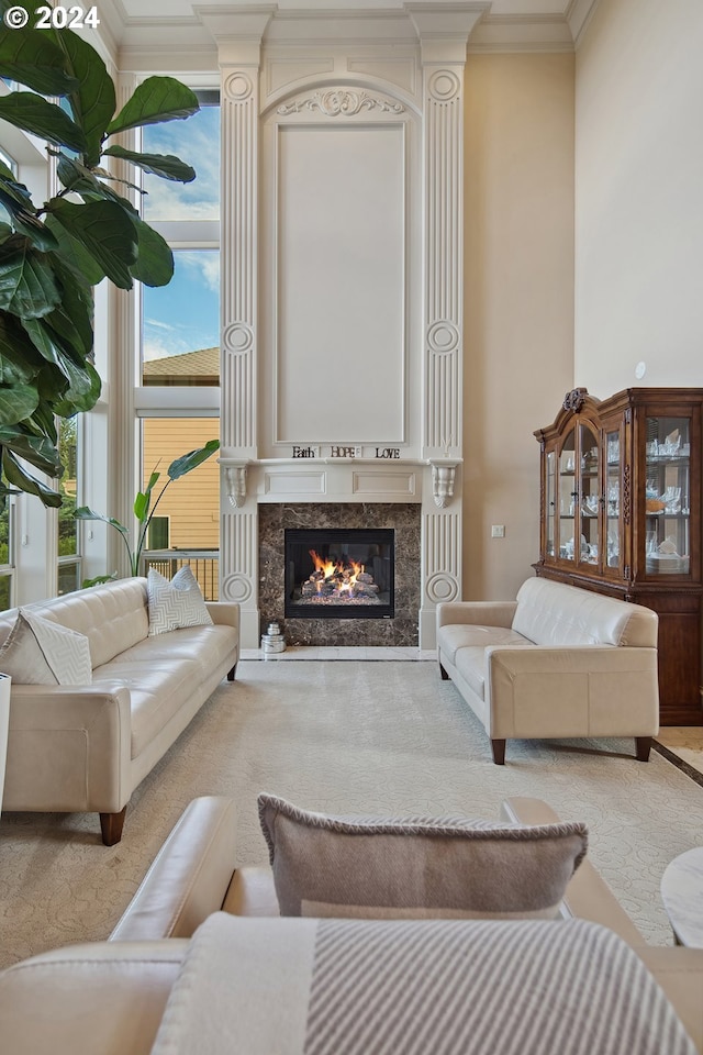 living room featuring crown molding, light carpet, and a fireplace