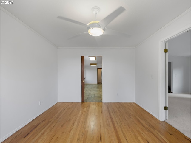 spare room with ornamental molding, light hardwood / wood-style floors, and ceiling fan