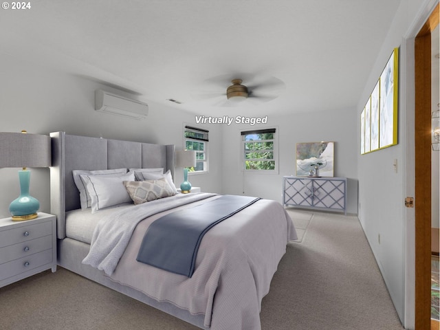 carpeted bedroom featuring a wall mounted AC and ceiling fan