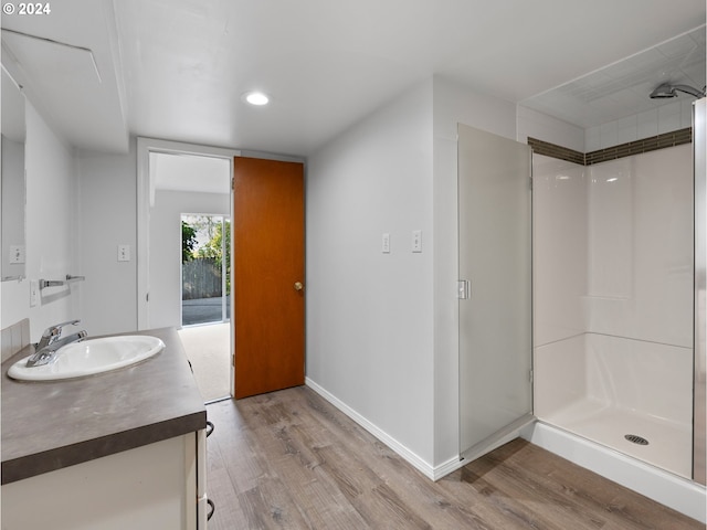 bathroom with vanity, hardwood / wood-style flooring, and a shower