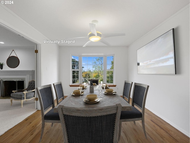 dining room featuring ornamental molding, wood-type flooring, and ceiling fan