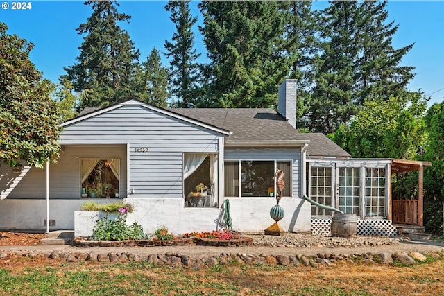 view of front of home featuring a sunroom