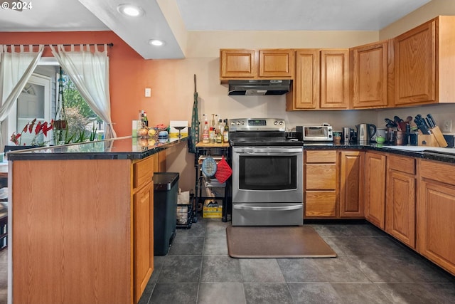 kitchen featuring stainless steel electric stove and dark tile patterned flooring