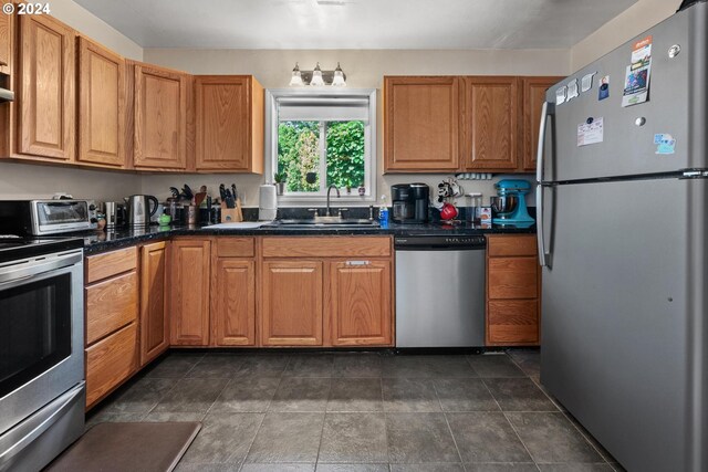 kitchen featuring appliances with stainless steel finishes, tile patterned floors, and sink