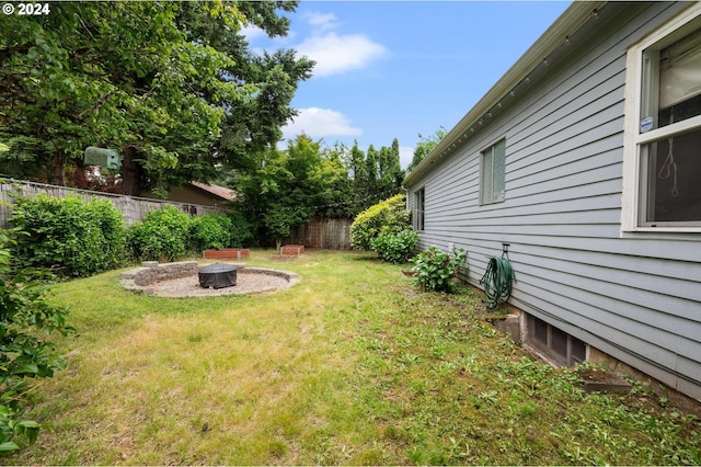 view of yard with an outdoor fire pit