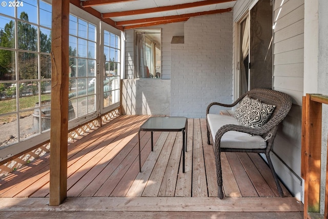 sunroom with vaulted ceiling with beams