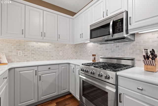 kitchen with white cabinetry, light countertops, tasteful backsplash, and appliances with stainless steel finishes