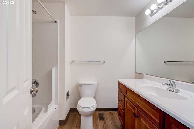 full bathroom featuring vanity, toilet, bathing tub / shower combination, and hardwood / wood-style floors