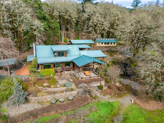 bird's eye view with a wooded view