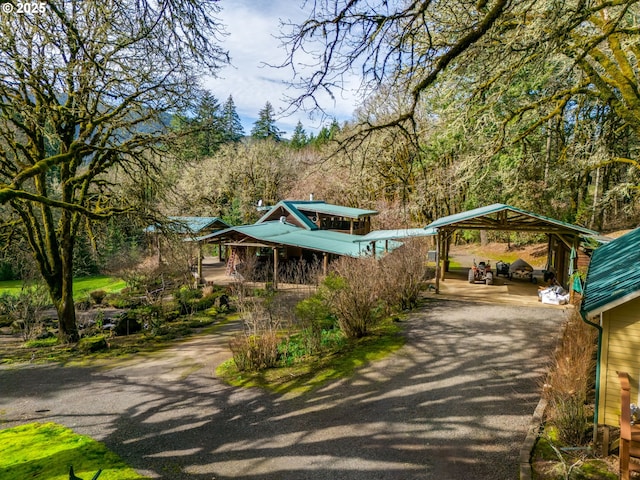 view of home's community with a detached carport and driveway